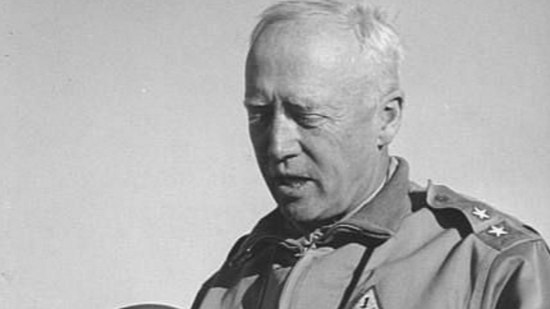 Gen. George S. Patton Jr. inspecting a tankers helmet while on training maneuvers in the desert in California