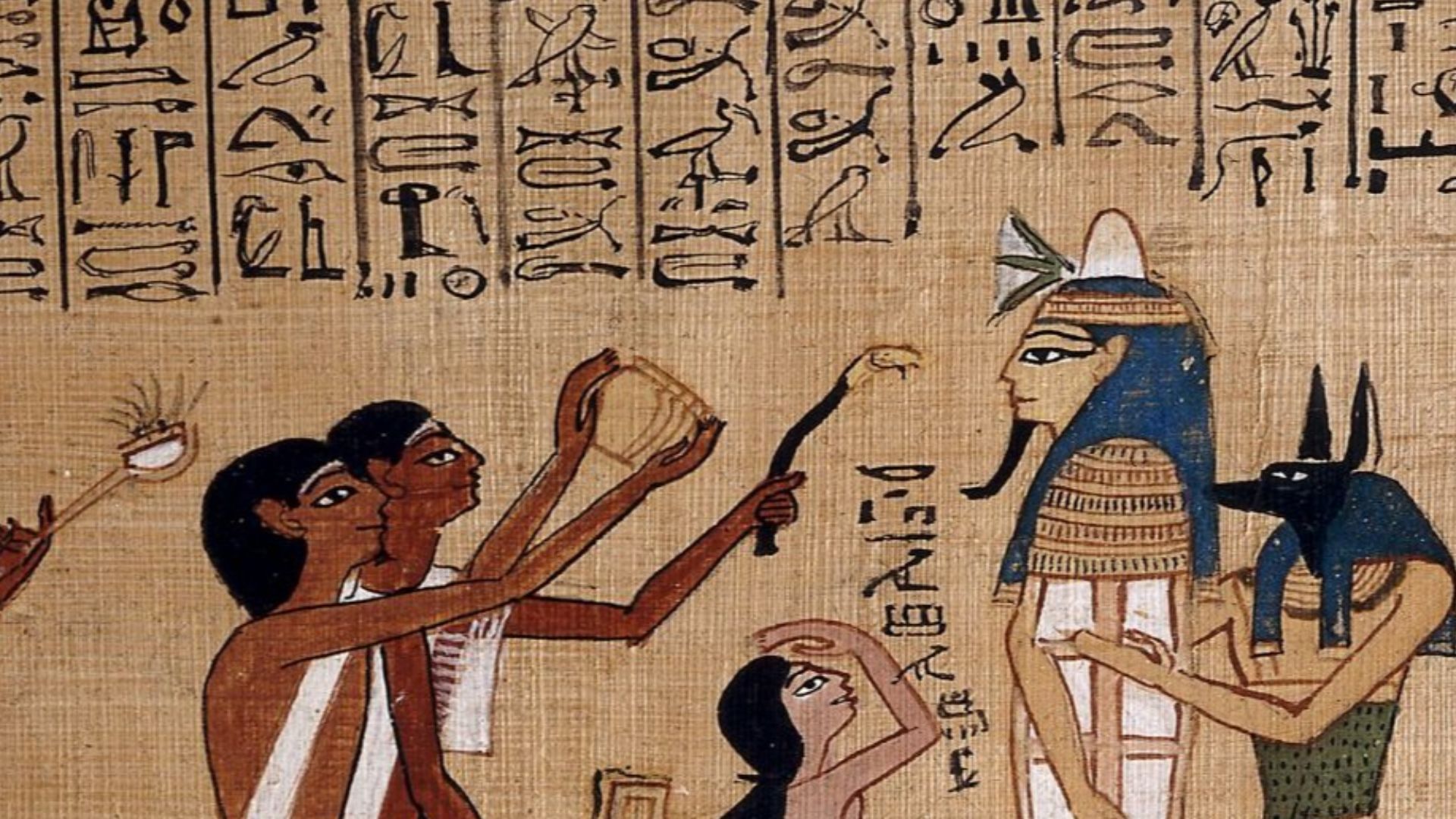 This is an excellent example of one of the many fine vignettes (illustrations) from the Book of the Dead of Hunefer.
The centrepiece of the upper scene is the mummy’s coffin, complete with death mask, of Hunefer, shown supported by the god Anubis (or a pr