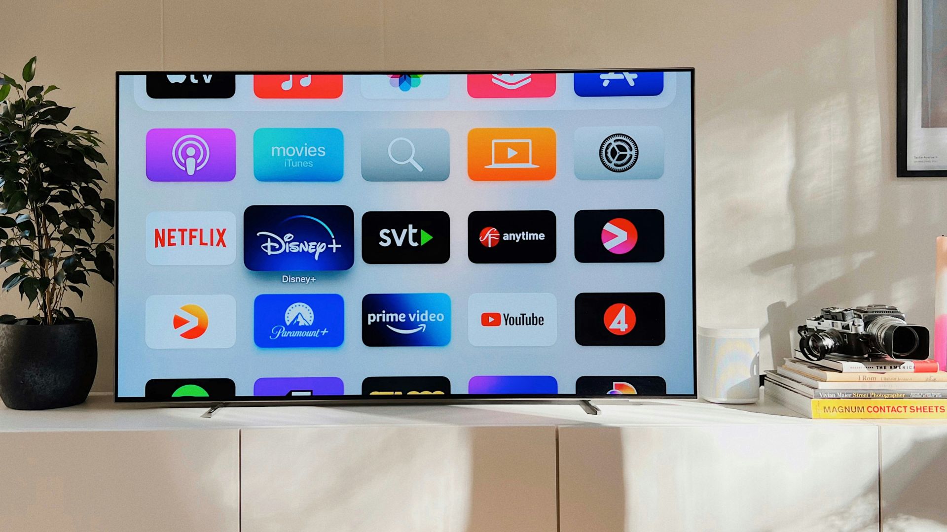 a flat screen tv sitting on top of a white cabinet