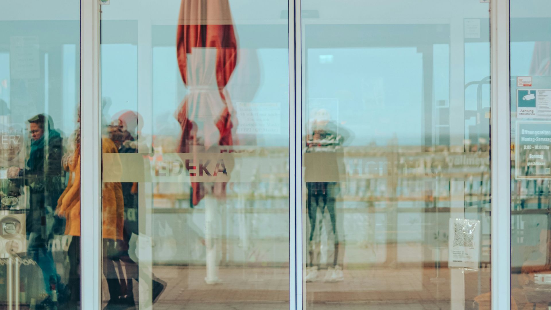 a store front with a few people walking in front of it