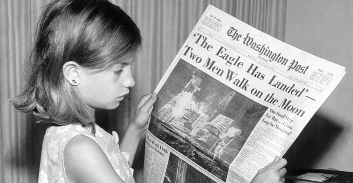 holding The Washington Post newspaper on Monday, July 21, 1969