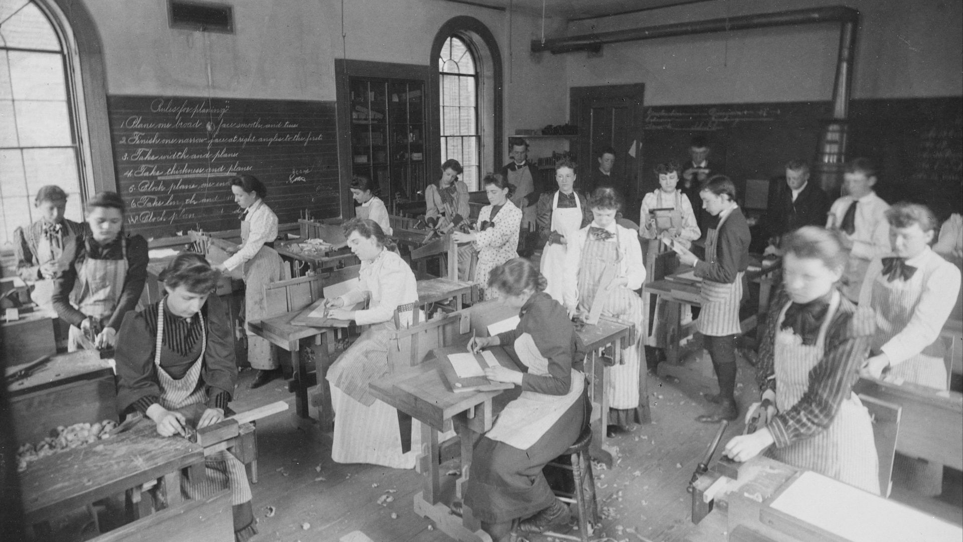 an old black and white photo of a classroom