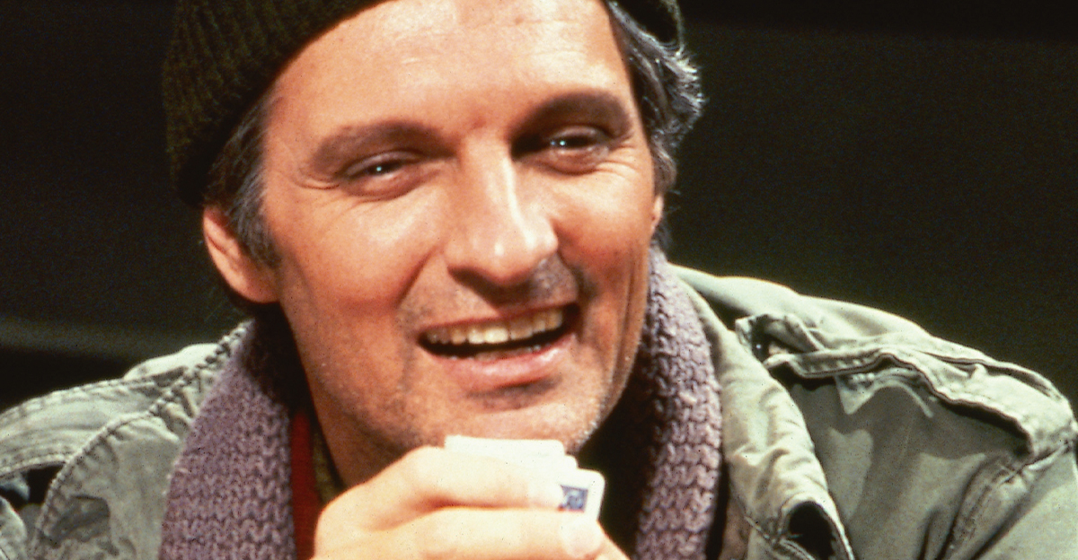 Alan Alda in a beanie and a green jacket