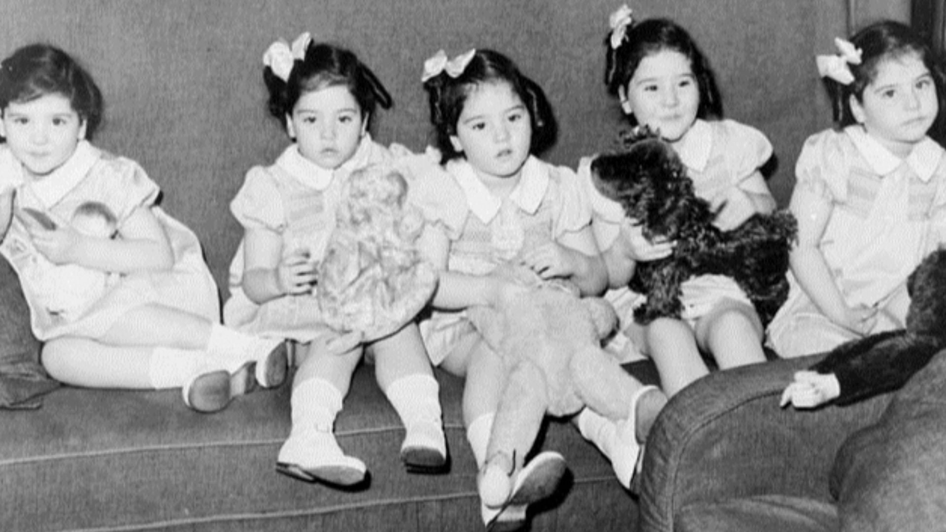 Dionne quintuplets in their train car, on trip to Toronto, Ont.