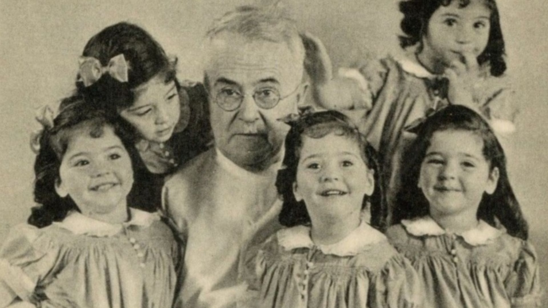 Allan Roy Dafoe with the Dionne quintuplets in 1938.