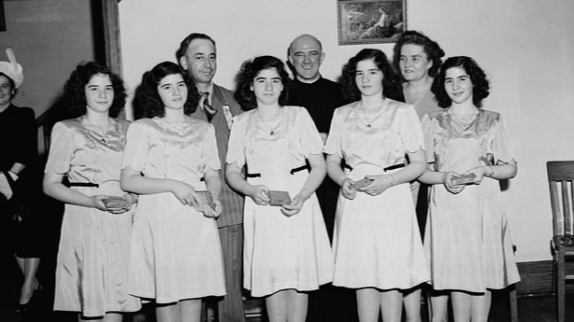 The Dionne quintuplets, accompanied by Mr Oliva Dionne and Frère Gustave Sauvé, take part in a program of religious music at Lansdowne Park, during the five day Marian Congress which prayed for peace and celebrated the centenary of the Ottawa archdiocese
