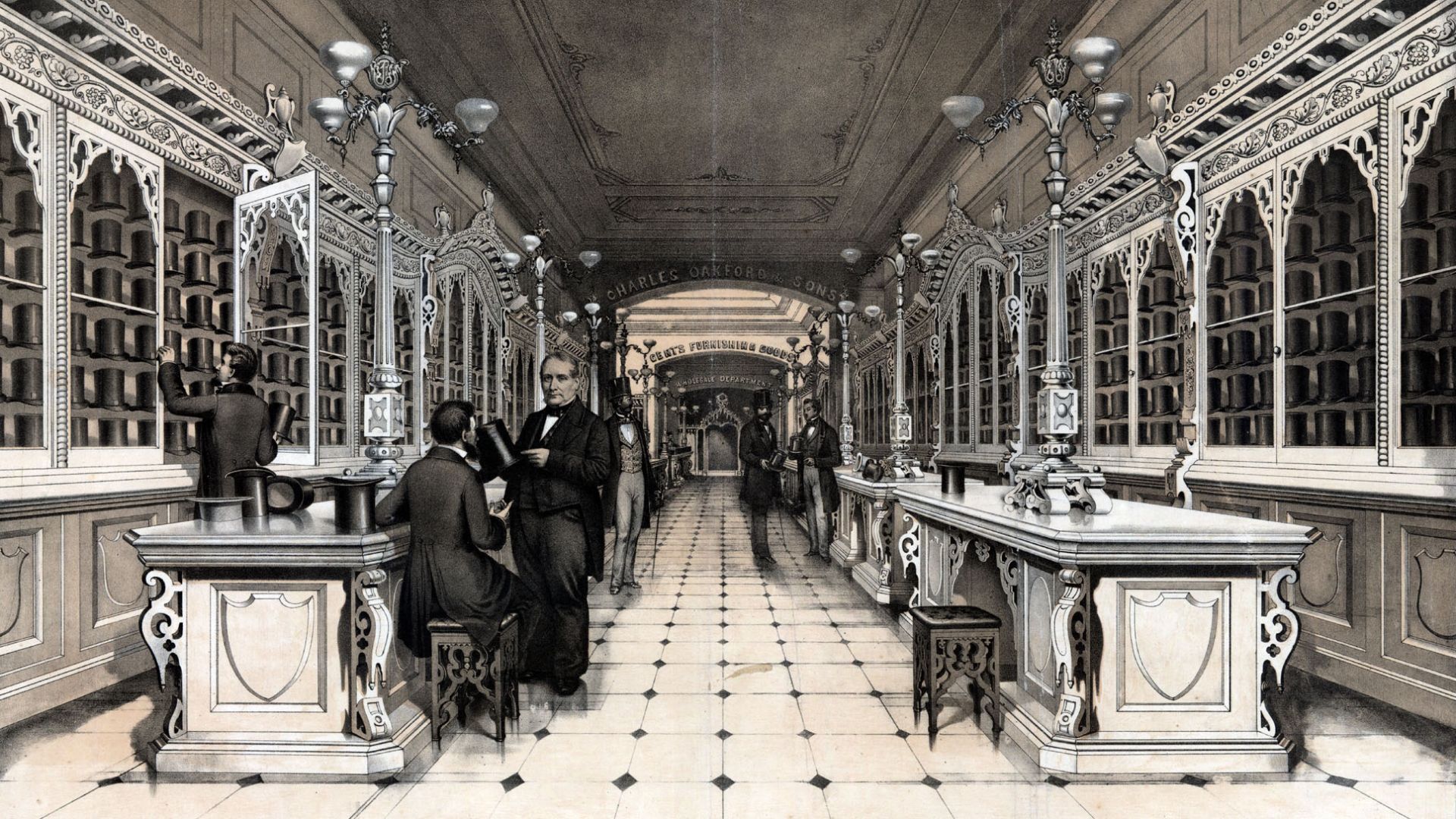 Advertisement showing the ornately furnished interior of the hat store established by Oakford in 1827. Fitting tables adorned with lavish free standing light fixtures in front of glass display cases filled with men's hats line the sides of the room. In th