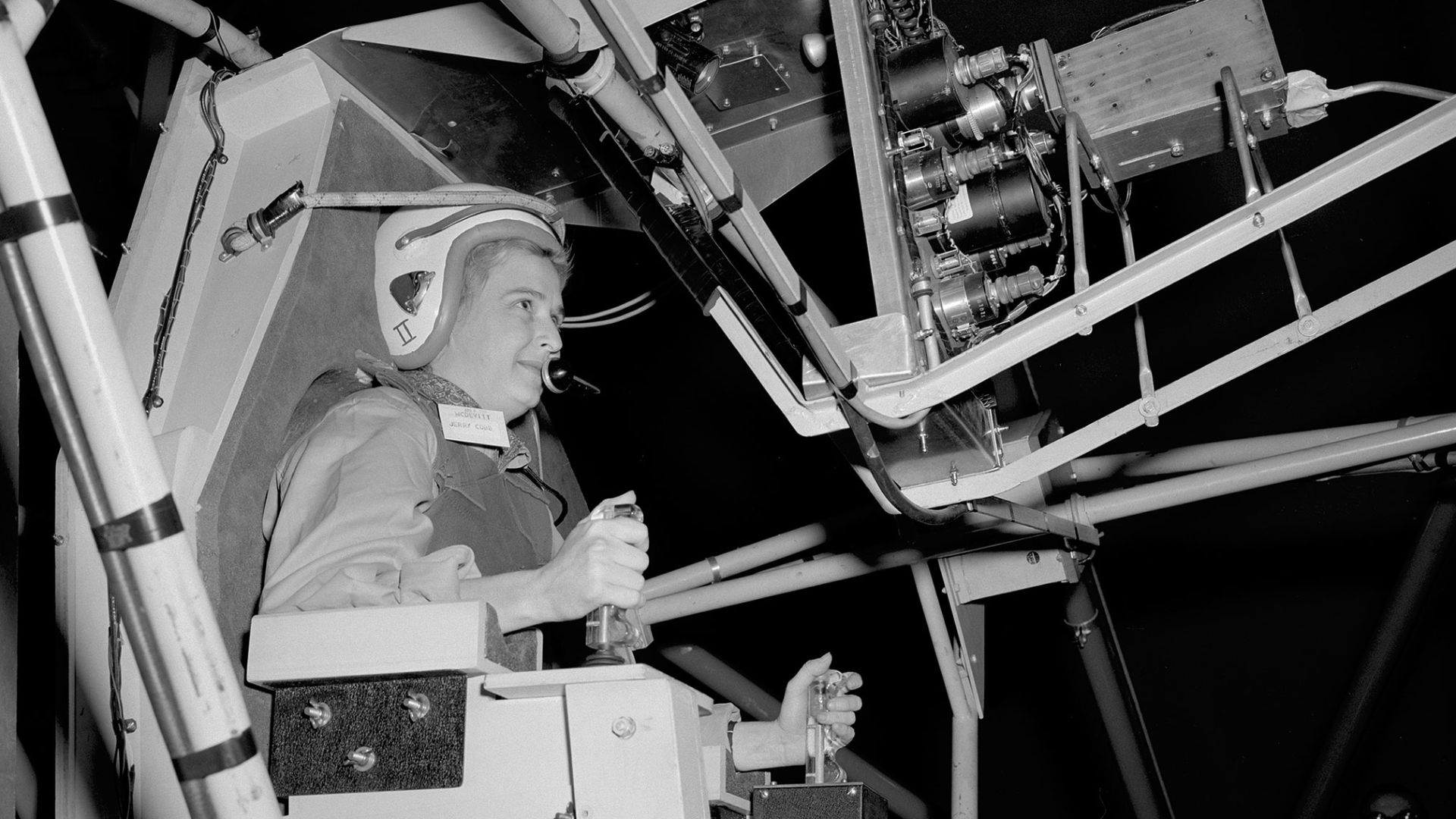 Jerrie Cobb prepares to operate the Multi-Axis Space Test Inertia Facility (MASTIF) inside the Altitude Wind Tunnel at the National Aeronautics and Space Administration (NASA) Lewis Research Center. The MASTIF was a three-axis rig with a pilot’s chair mou