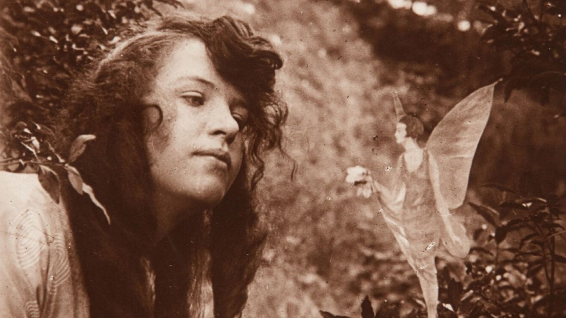 The fourth of the Cottingley Fairies photographs, showing Elsie Wright with a fairy