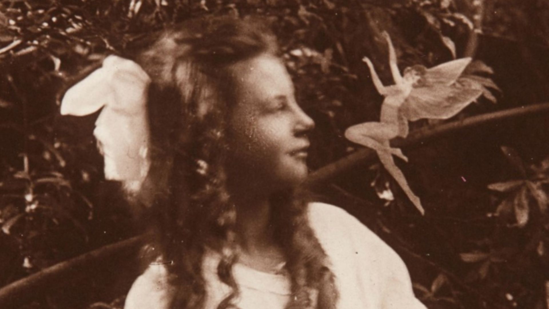 The third of the Cottingley Fairies photographs, showing Frances Griffiths with a fairy