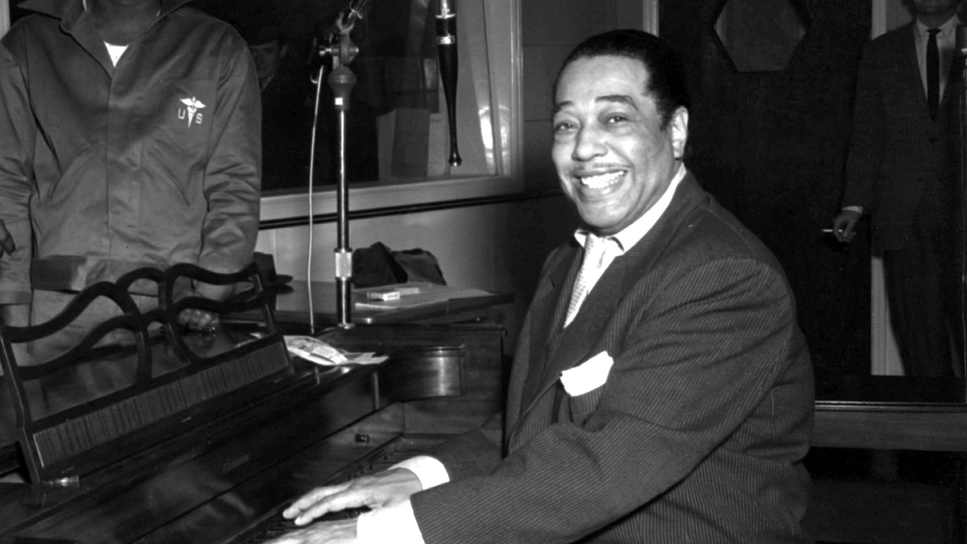 Duke Ellington, a famous jazz musician, poses with his piano at the KFG Radio Studio. KFG is Fitzsimons Army Medical Center's radio station.