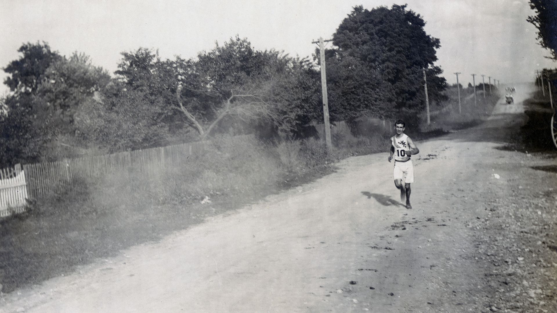 Sam Mellor of the Mohawk Athletic Club running alone, along the dirt road, in the Marathon Race at the 1904 Olympics.Title: Sam Mellor of the Mohawk Athletic Club from New York City, running in the Marathon Race at the 1904 Olympics.