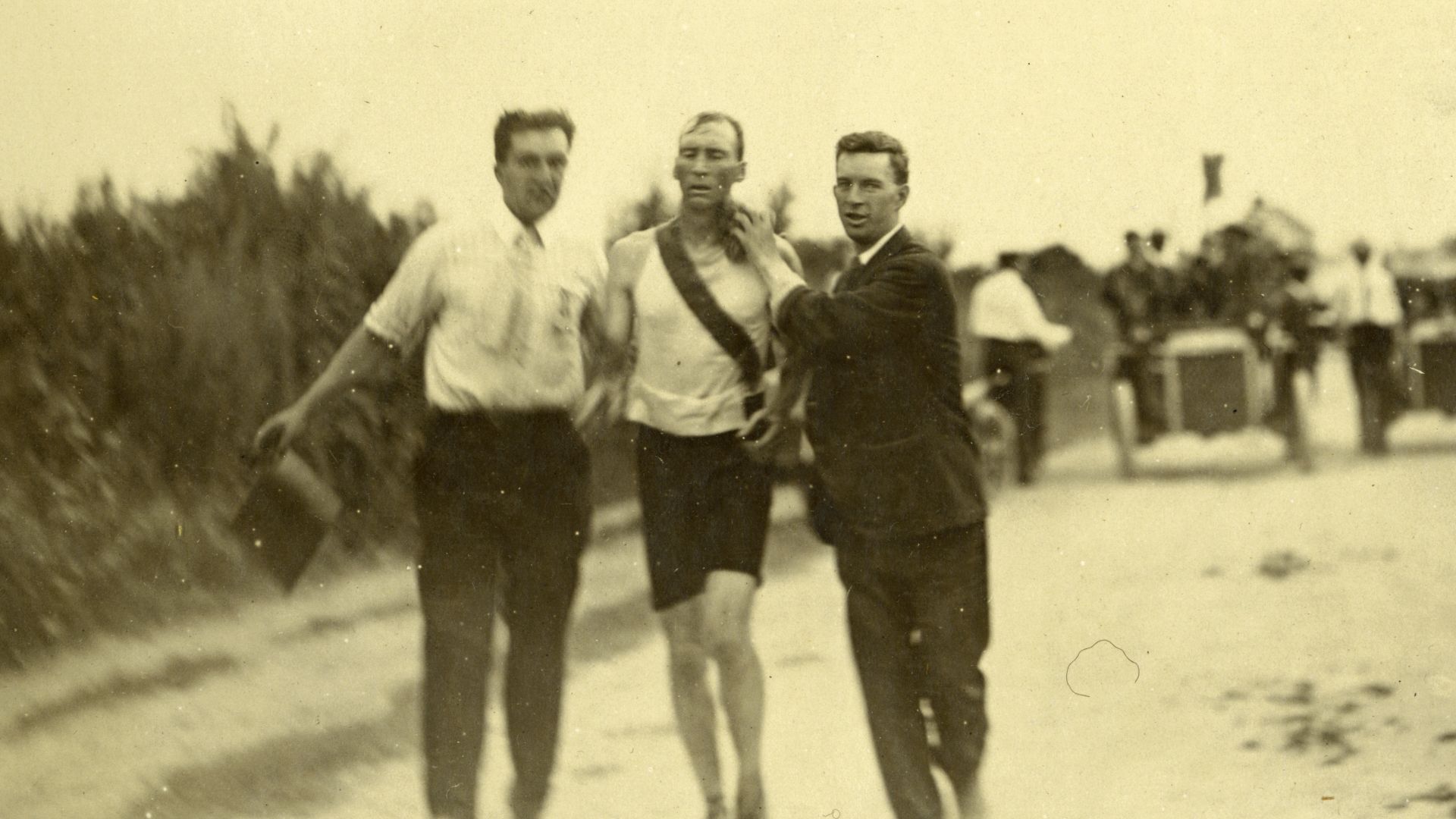 Title: T.J. Hicks of Cambridge, Massachusetts. Winner of Marathon Foot-Race being sponged by attendants. 1904 Olympics.