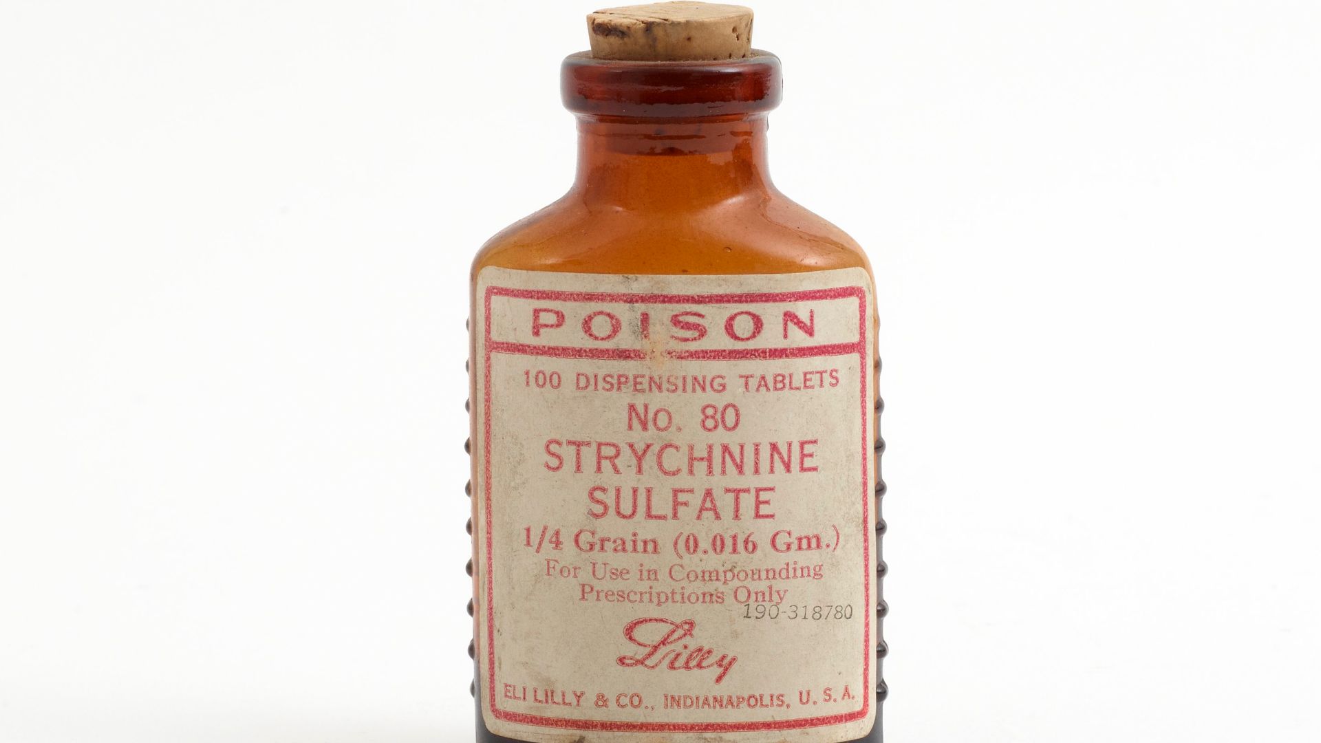 Bottle of Strychnine Sulfate tablets in a brown glass bottle with cork top closure. Strychnine is a highly toxic, colorless, crystalline alkaloid used today as a pesticide for rodents or birds. When inhaled, swallowed, or absorbed through the eyes or mout