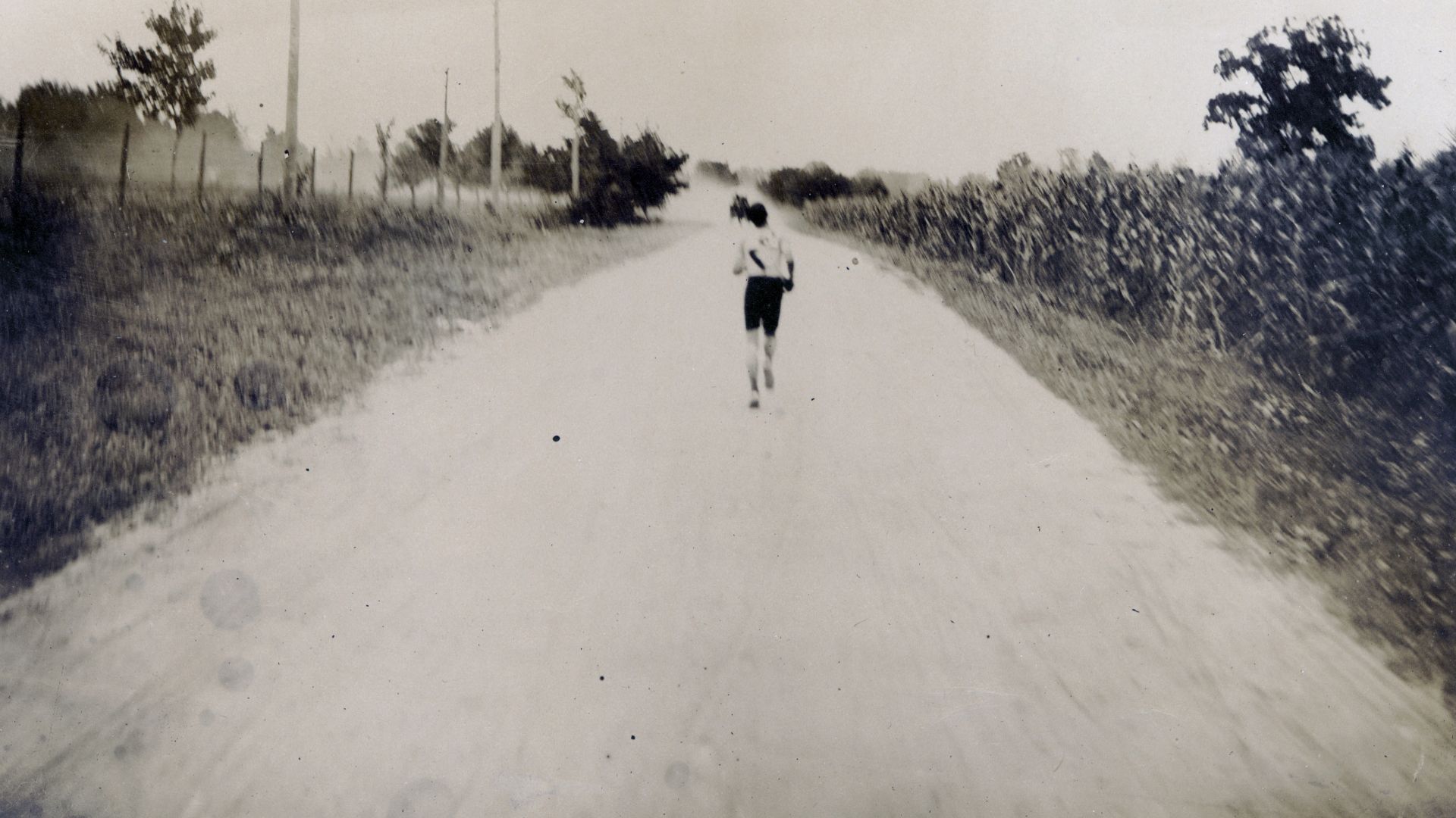 Title: Thomas J. Hicks of Cambridge, Massachusetts YMCA leading the 1904 Olympic Marathon runners at the 20 mile mark.