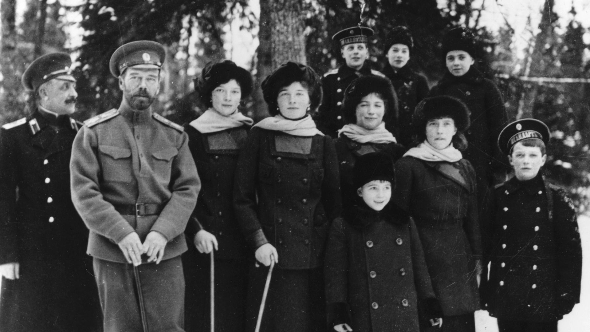 Tsar Nicholas II of Russia with members of his family in the private grounds of Tsarskoe Selo.(l-r) Aide-de-camp Sablin, Tsar Nicholas II, the Grand Duchesses Tatiana, Olga, Maria, Anastasia and Tsarevich Alexei. In front of Maria is Prince Vasili, behind