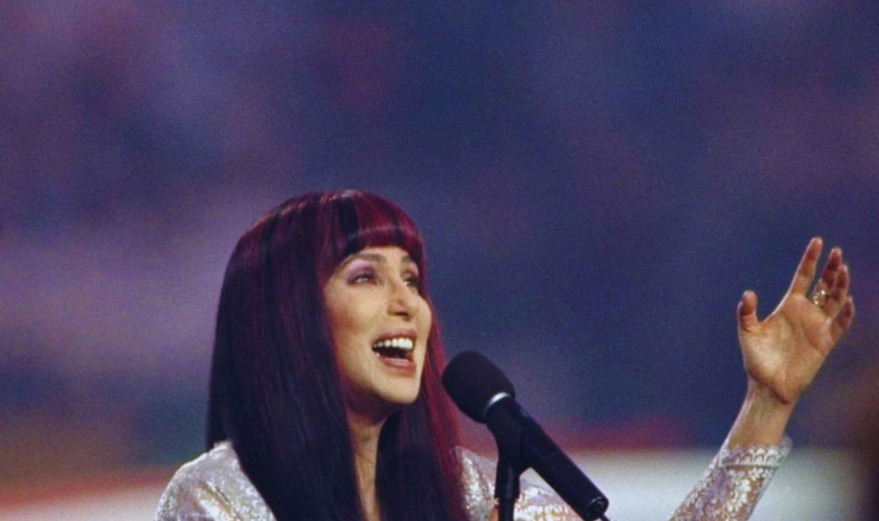 31 Jan 1999: Cher sings the National Anthem during the pre-game show for Super Bowl XXXIII between the Atlanta Falcons and the Denver Broncos at Pro Player Stadium in Miami, Florida. The Broncos defeated the Falcons 34-19.