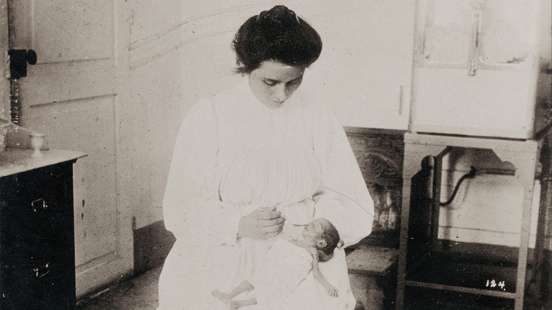 Title: Nurse feeding a premature baby in the Baby Incubator exhibit on the Pike at the 1904 World's Fair. [.