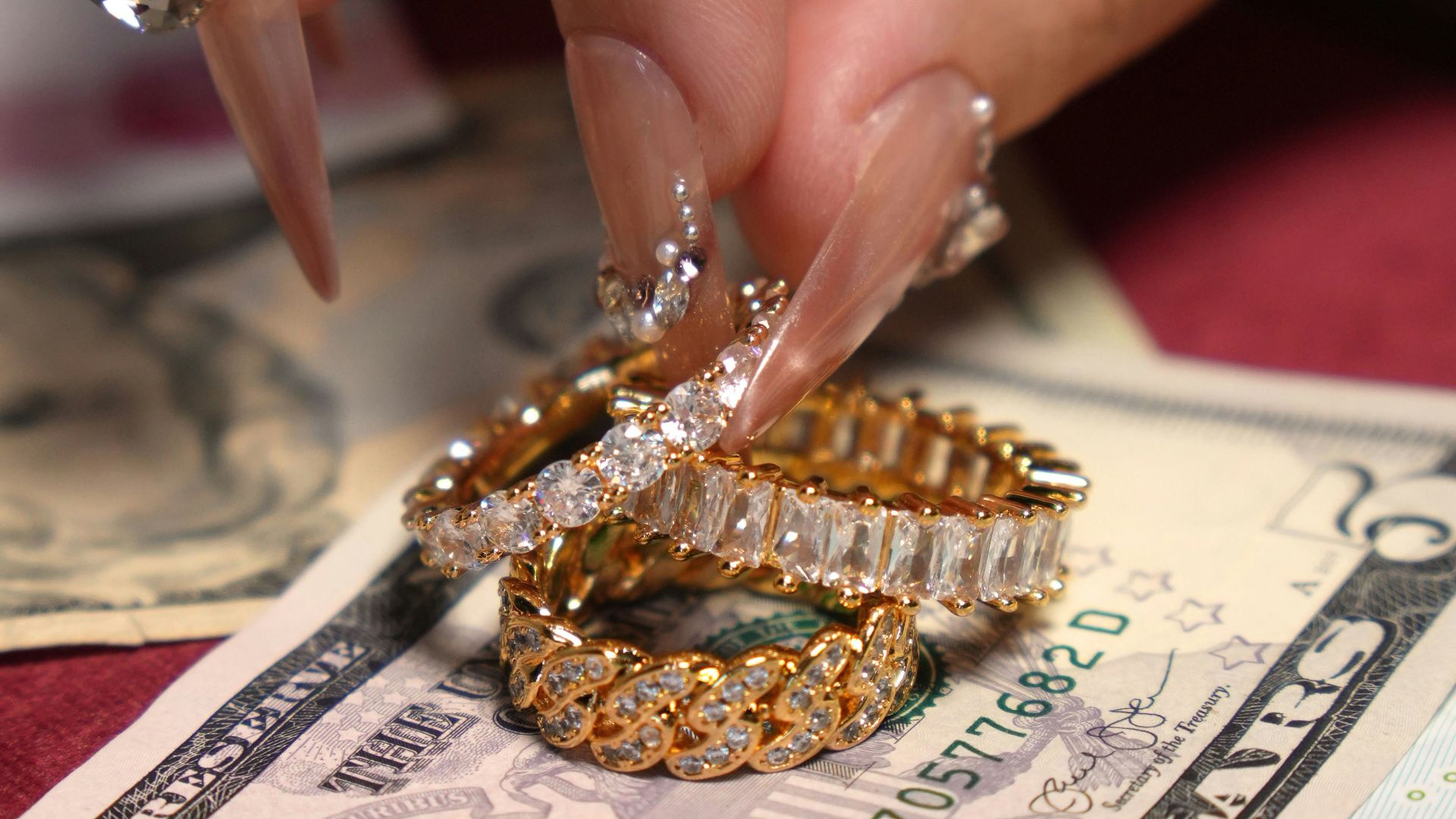 Diamond rings resting on us dollar bills