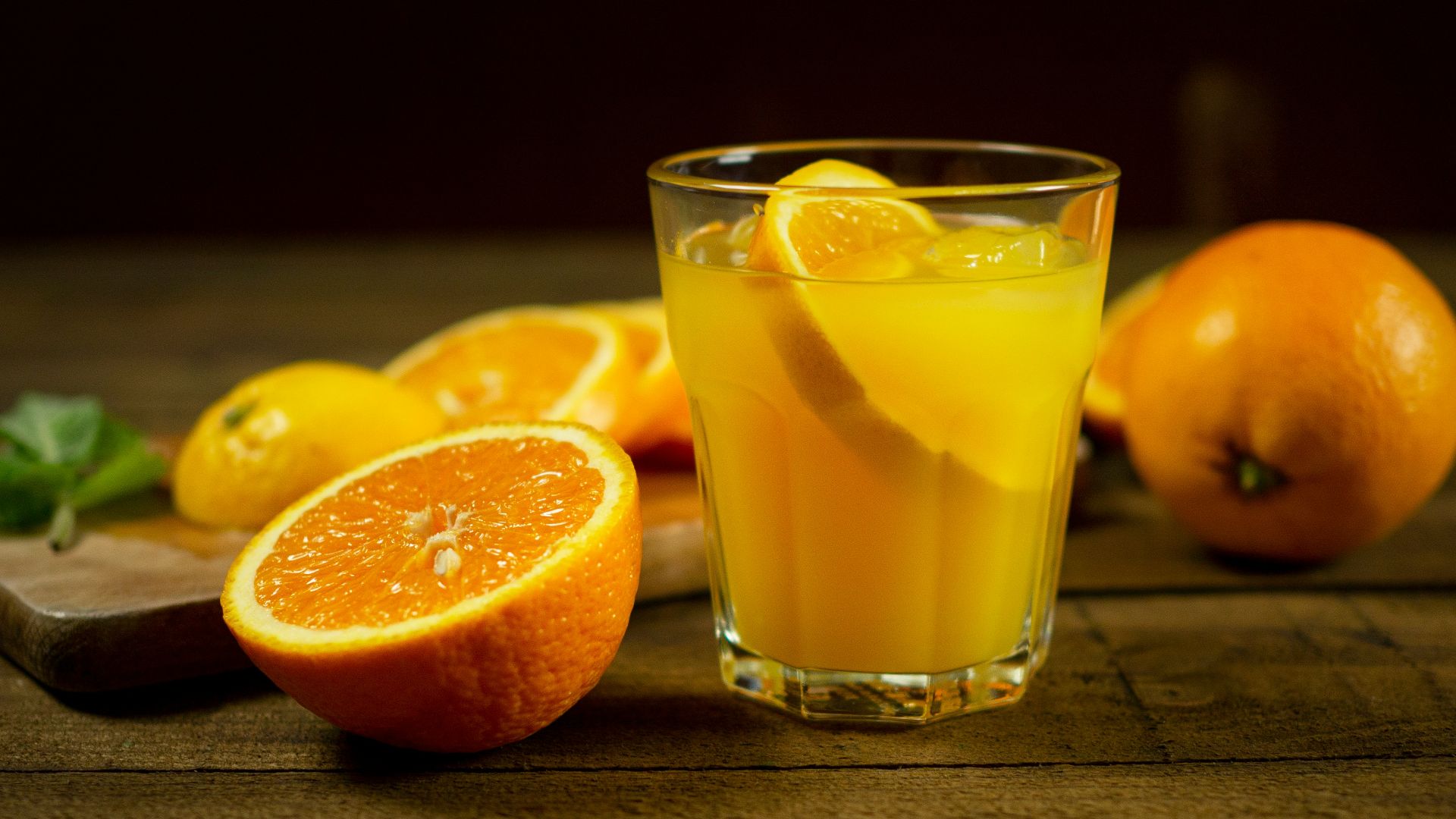 orange juice in clear drinking glass