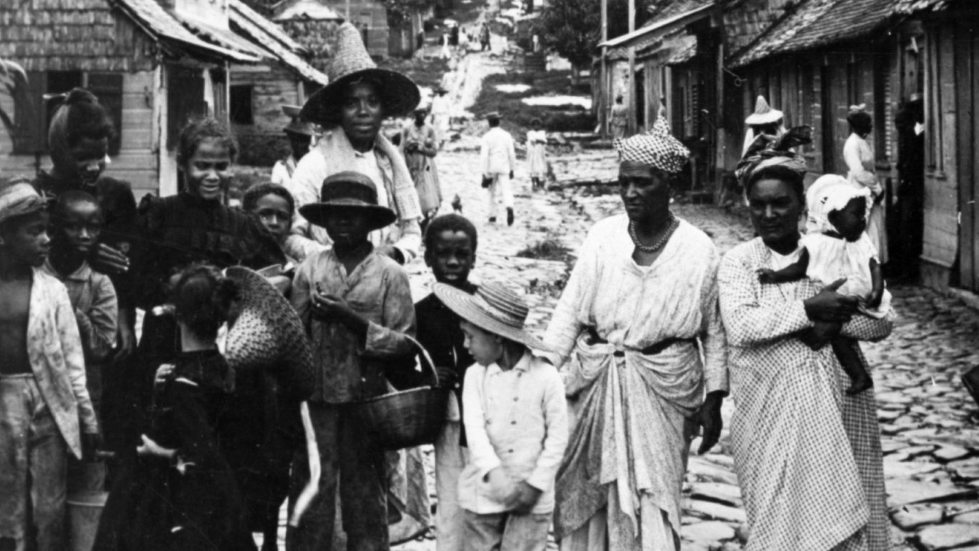 A group of refugees on Rue du Pavé, Fort de France - Martinique, following the eruption of Mount Pelée in 1902.  Left half of a stereoscope card.
