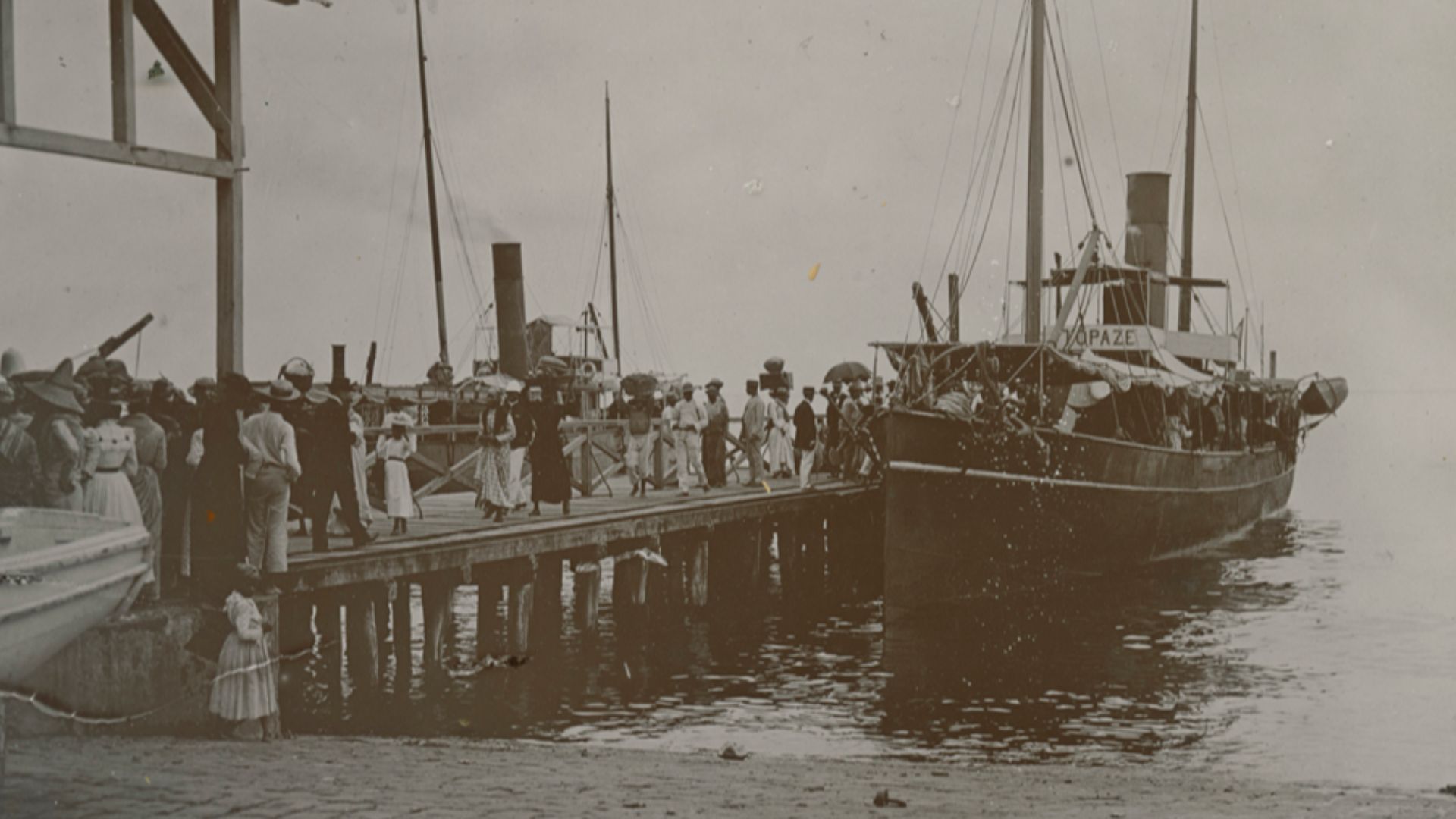 Title: [Ship at dock before eruption of Mt. Pelee]
Creator: Cooper, W.G.
Date: 1902
Part Of: Mt. Pelee volcano, St. Pierre, Martinique
Description: Photograph from album that includes views of Martinique and destruction, dead, and rubble from the eruption