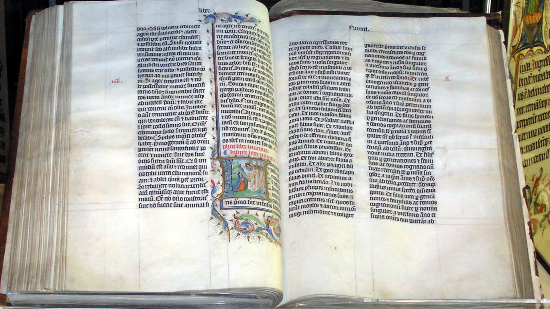A Bible handwritten in Latin, on display in Malmesbury Abbey, Wiltshire, England. This Bible was written in Belgium in 1407 AD, for reading aloud in a monastery.