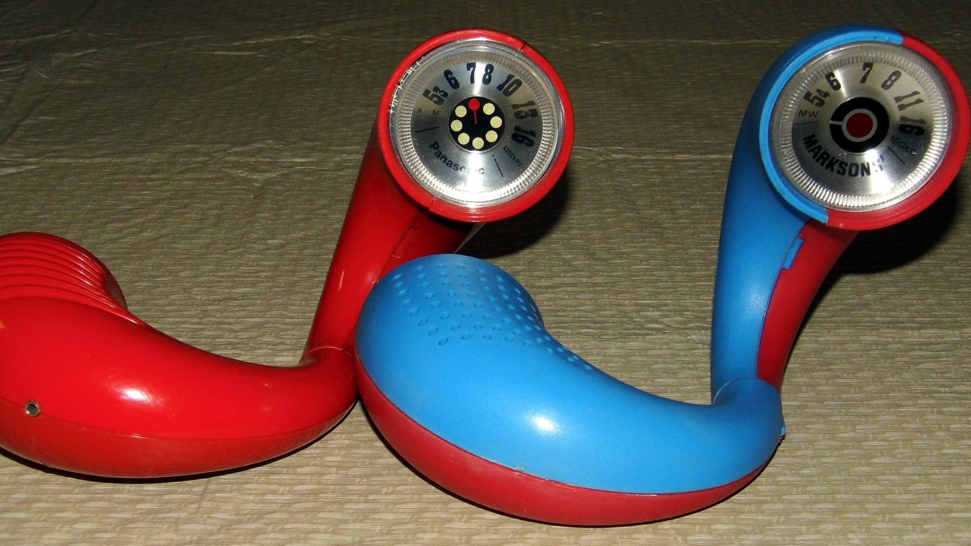 (Left) A Vintage Panasonic Toot-A-Loop AM Transistor Radio, Model R-72, Made in Japan and (Right) An Inexpensive Knock-Off, A Marksons' AM Wrist Radio Made in Hong Kong