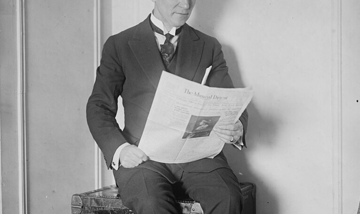 man reading newspaper 