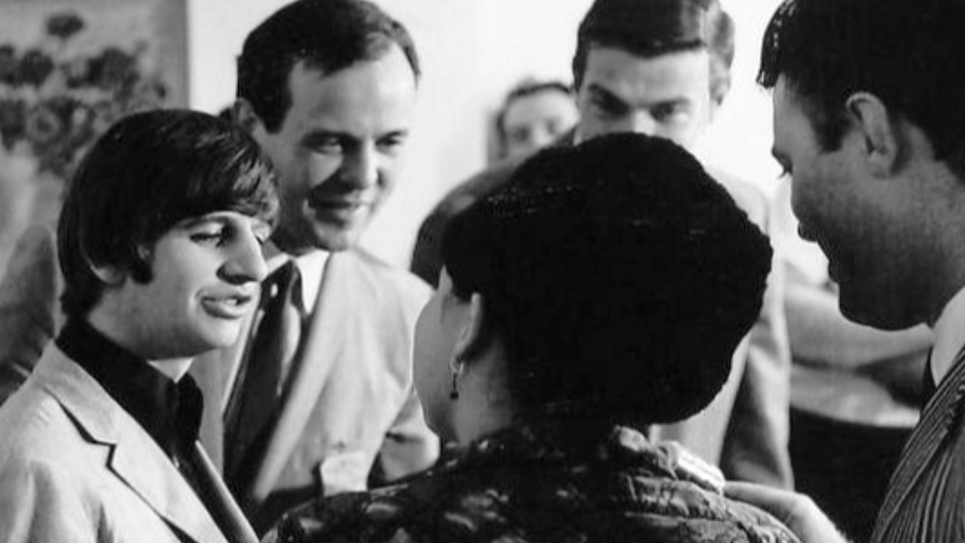 Photo of Ringo Starr. This appears to have been taken when he was one of the Beatles.  Taken by a New York photographer at an unnamed location, the photo also appears to include Beatles' manager Brian Epstein, or his assistant, Peter Brown, who had a rese