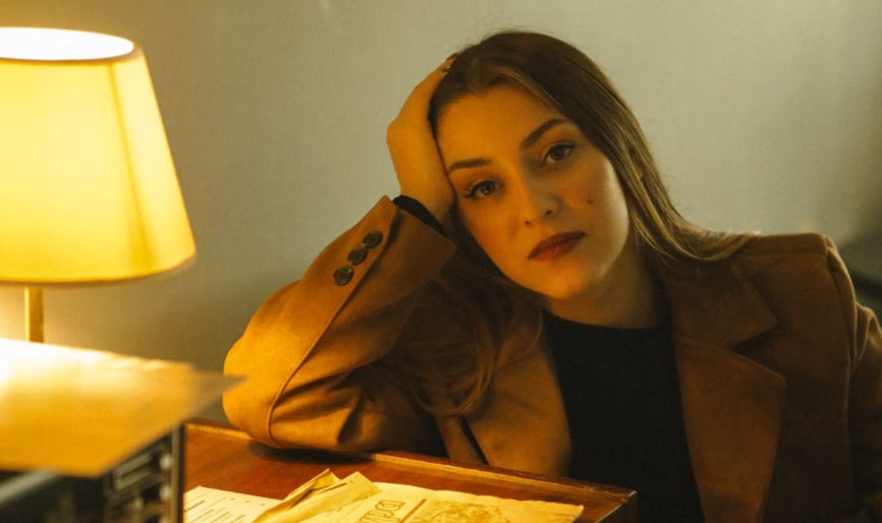 woman sitting next to the lamp