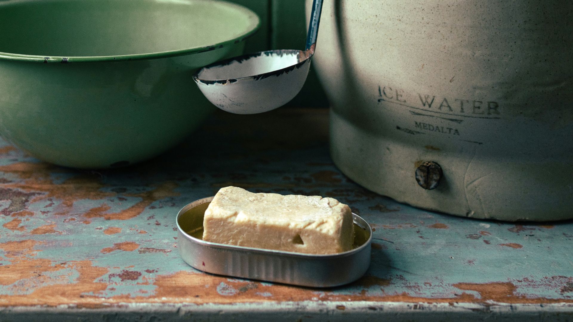 stainless steel cooking pot beside white ceramic bowl