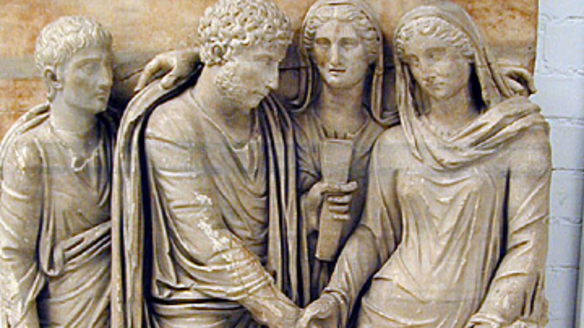 Fragment from the front of a sarcophagus; relief in blue-veined marble with large crystals (probably Proconnesian), showing a Roman marriage ceremony; dextratrum iunctio. Between the bride and groom was a figure (now missing) of the god Hymenaeus, who car
