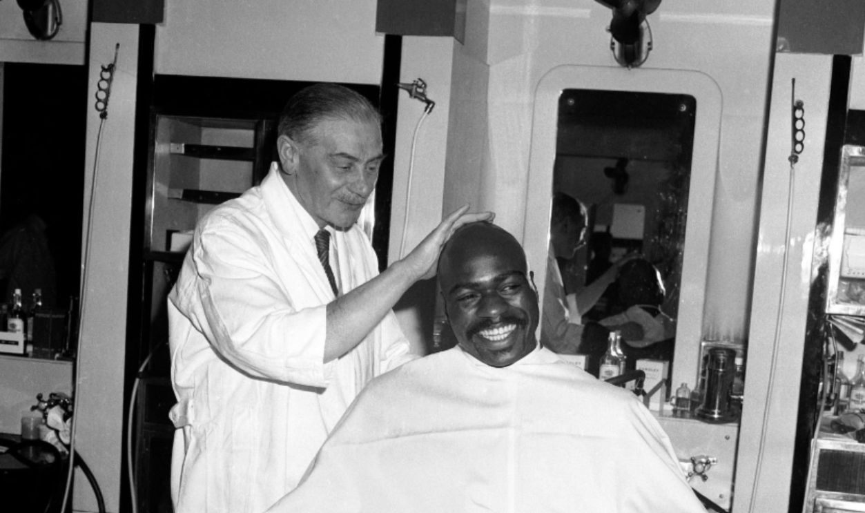American middleweight Rubin Carter visits a barber after arriving in London for his bout with Harry Scott on March 9th 