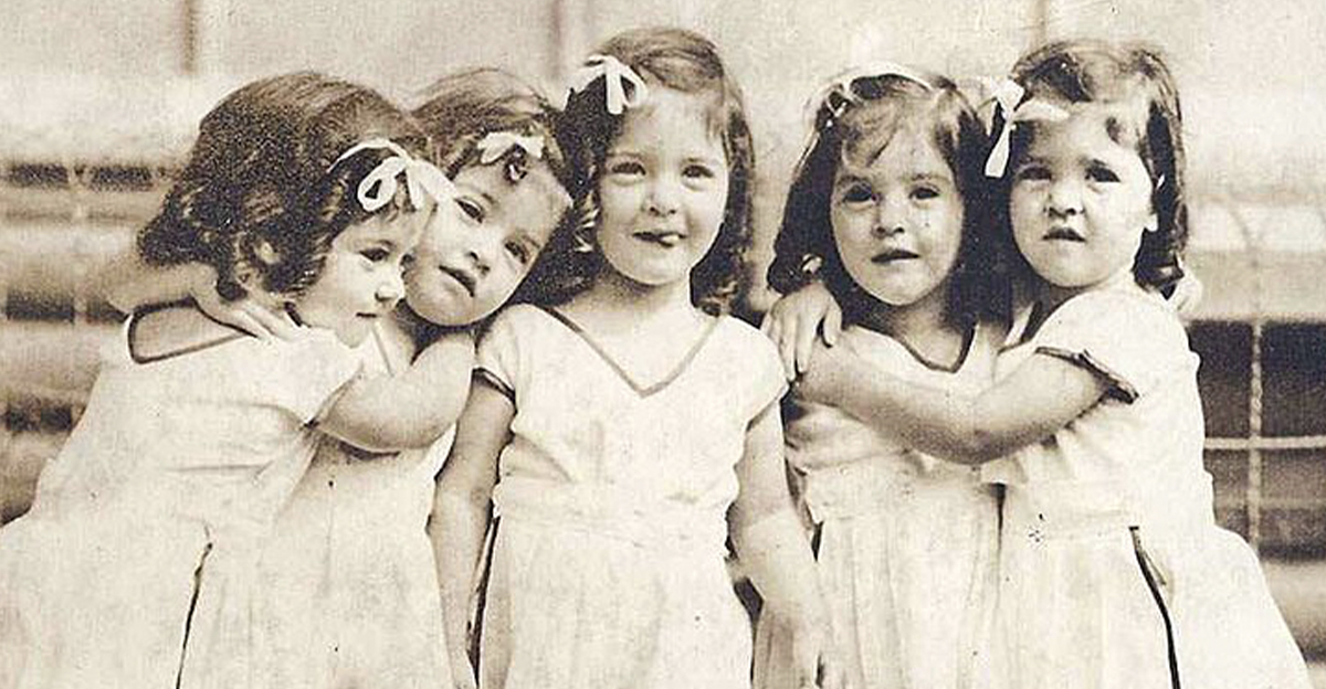 The Dionne Quintuplets in white dresses