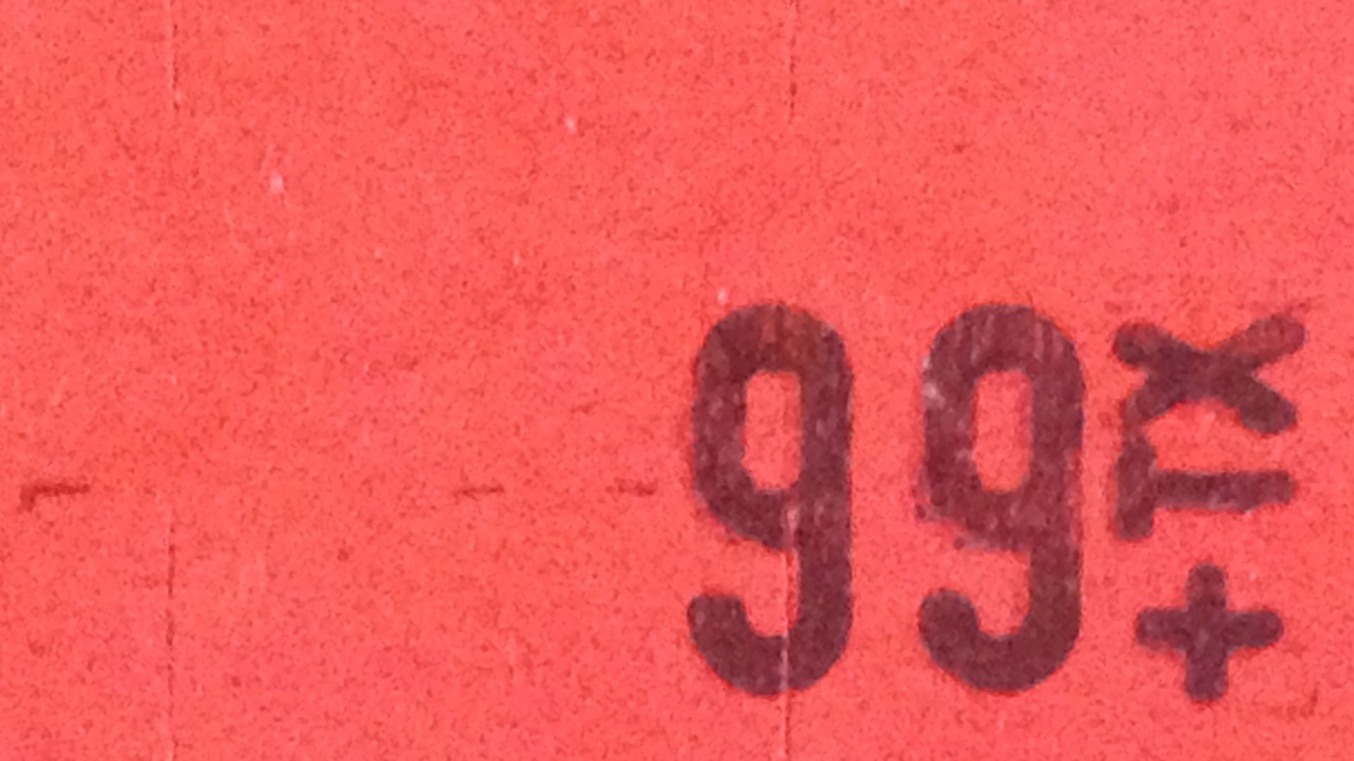 Plain Red price tag as applied with a Price Tag Label Gun.