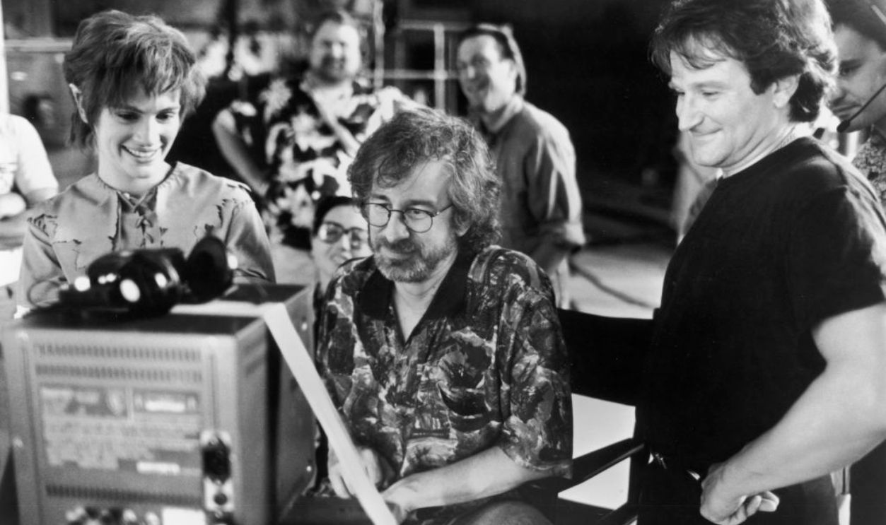 Actors Julia Roberts and Robin Williams watch daily production footage with director Steven Spielberg on the set of his film, 'Hook,' 1991.