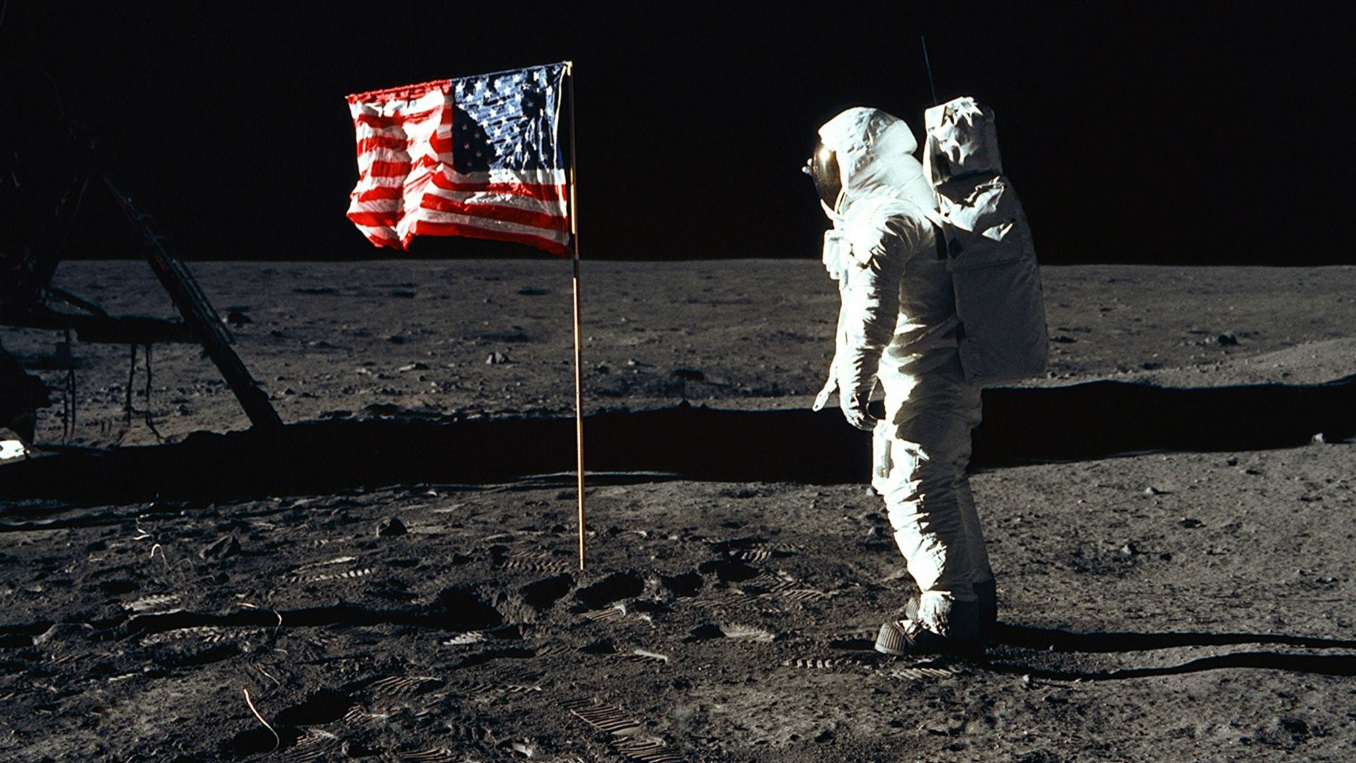 Buzz Aldrin on the moon in front of the US flag