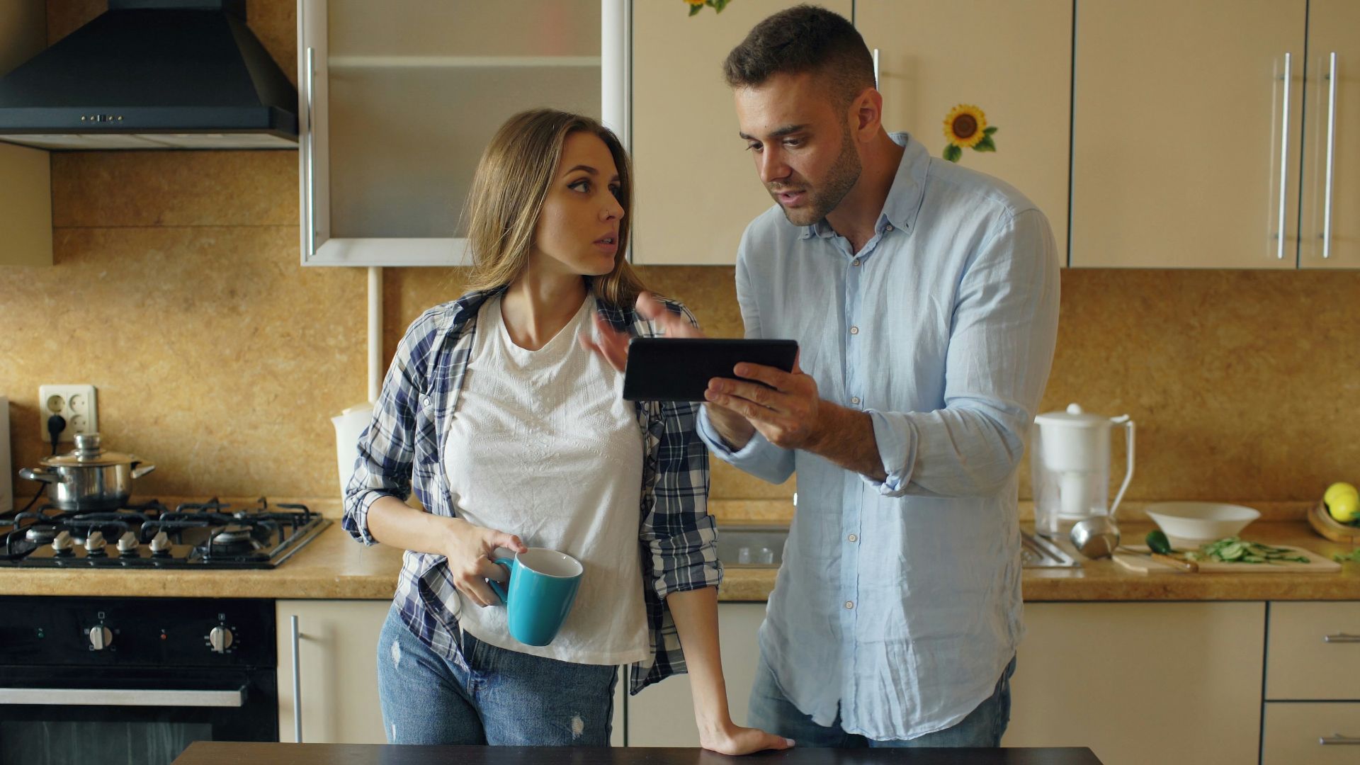 Couple looking at tablet in kitchen