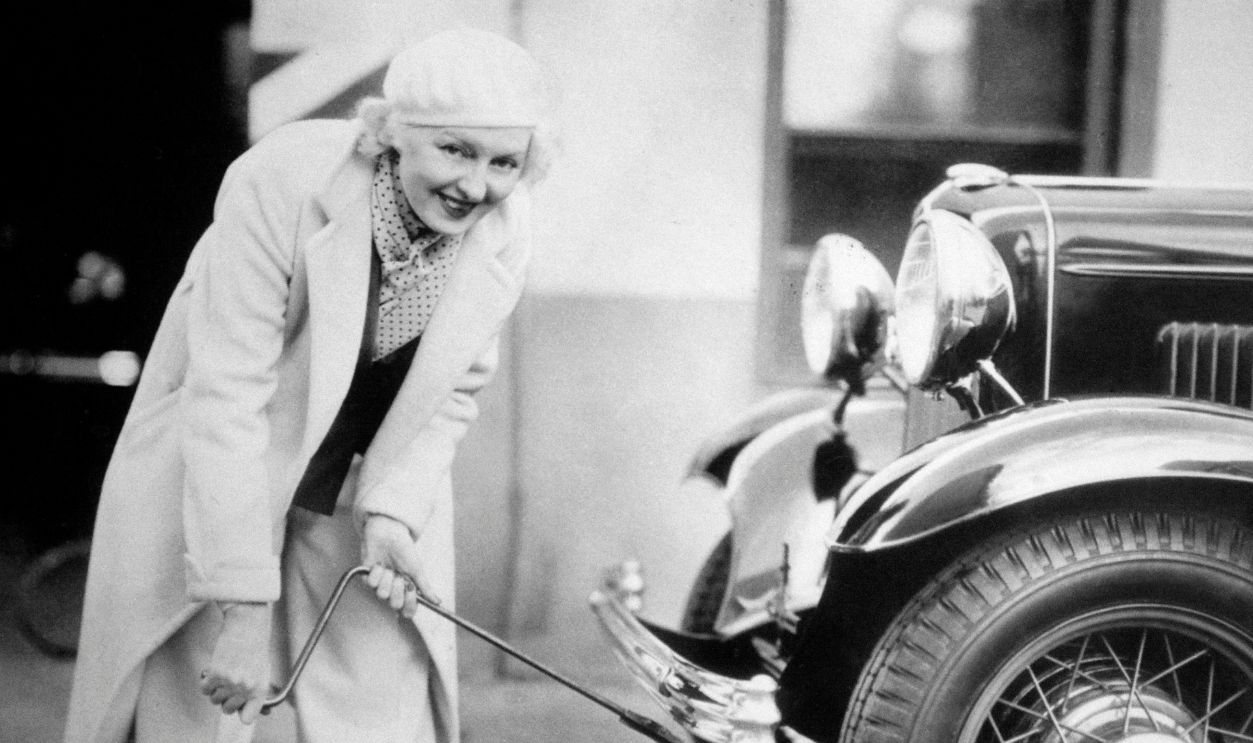 The fiercely independent Peggy Hopkins Joyce changing a tire on her car in Los Angeles, California, USA, on March 6, 1933.