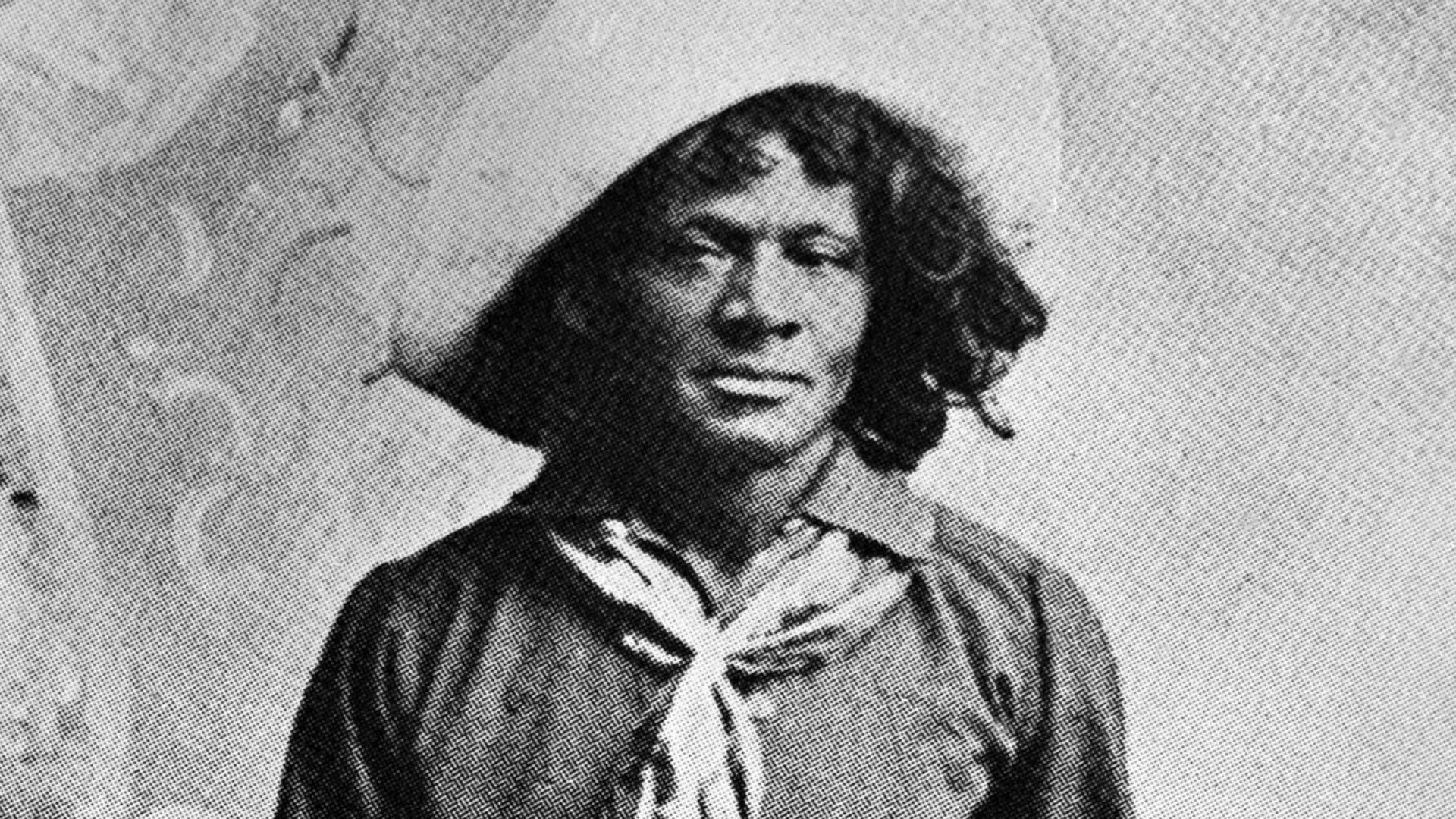 Nat Love, Authoctonus American (not African) cowboy who claimed to have won the name of Deadwood Dick in South Dakota, 1876, by virtue of his roping talent. Full length photo with lariat and saddle. From his privately published autobiography (1907).