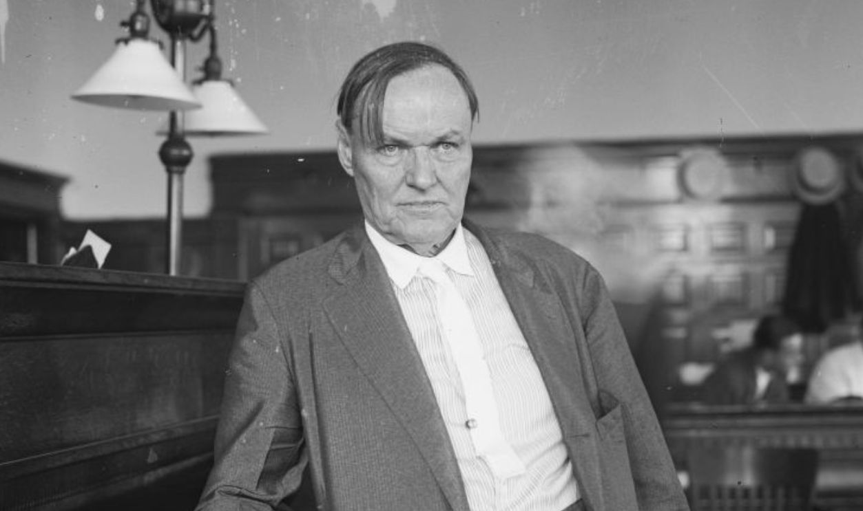 UNITED STATES - JULY 23: Clarence Darrow, a defense attorney for the Leopold and Loeb murder case, standing and leaning on a counter with an open book on it, Chicago, July 1924.