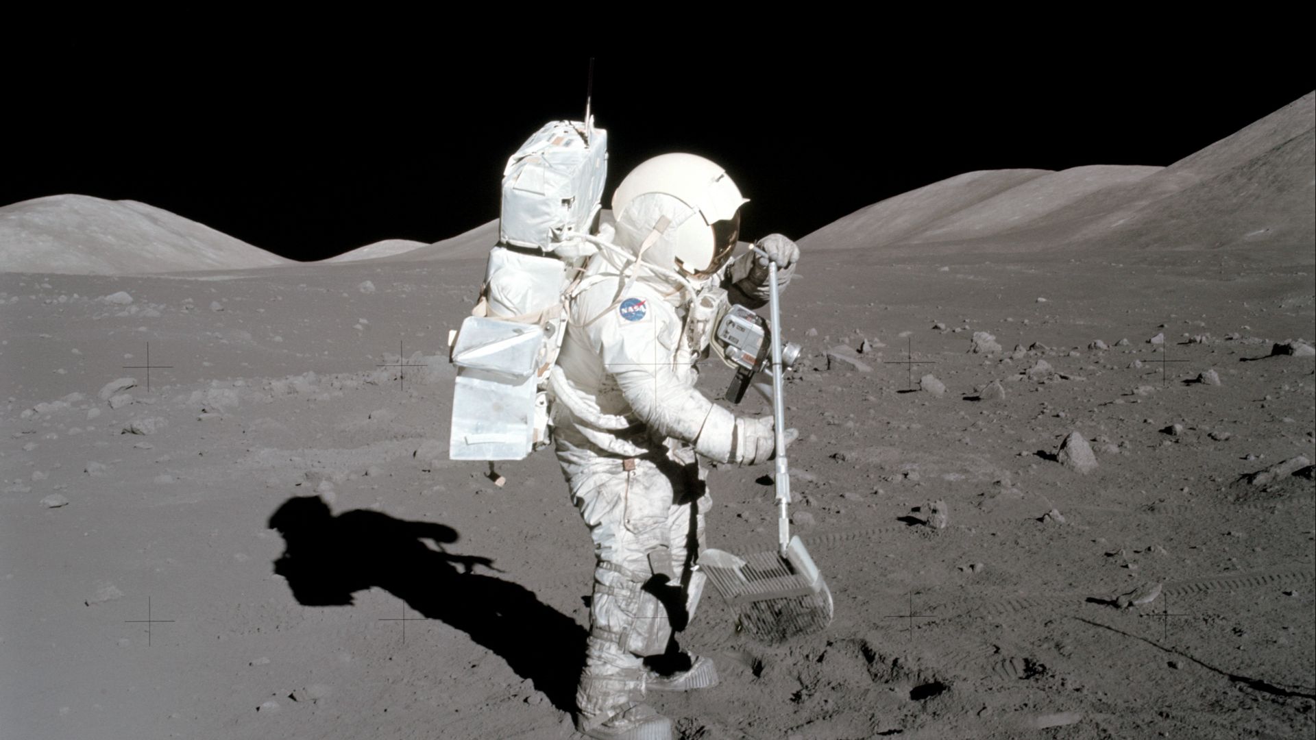 AS17-134-20425 (11 Dec. 1972) --- Scientist-astronaut Harrison H. Schmitt, lunar module pilot, collects lunar rake samples at Station 1 during the first Apollo 17 extravehicular activity (EVA) at the Taurus-Littrow landing site. This picture was taken by