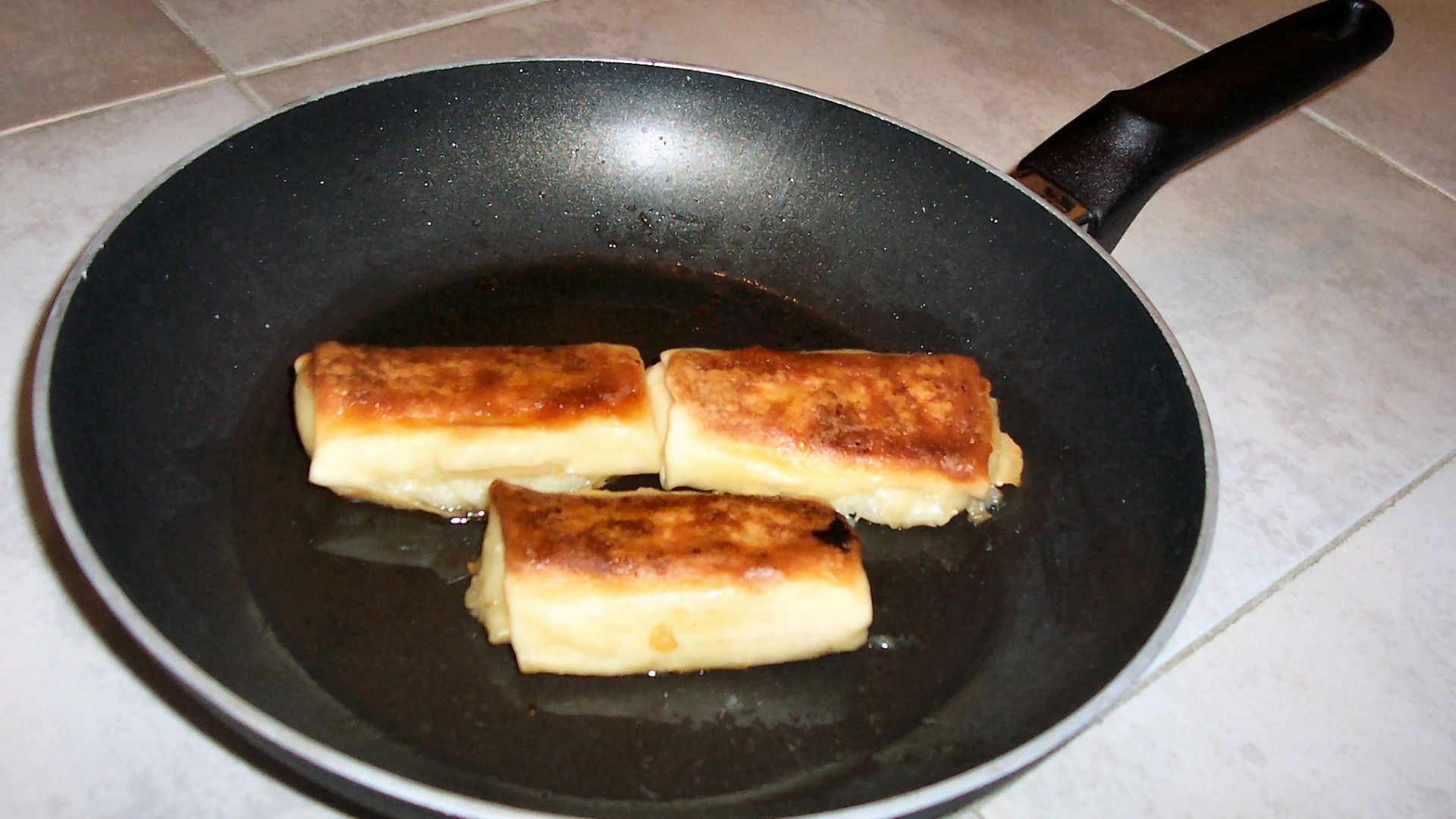 Freshly cooked frozen w:blintzes in a frying pan. Photo taken by me, in the kitchen of my house.