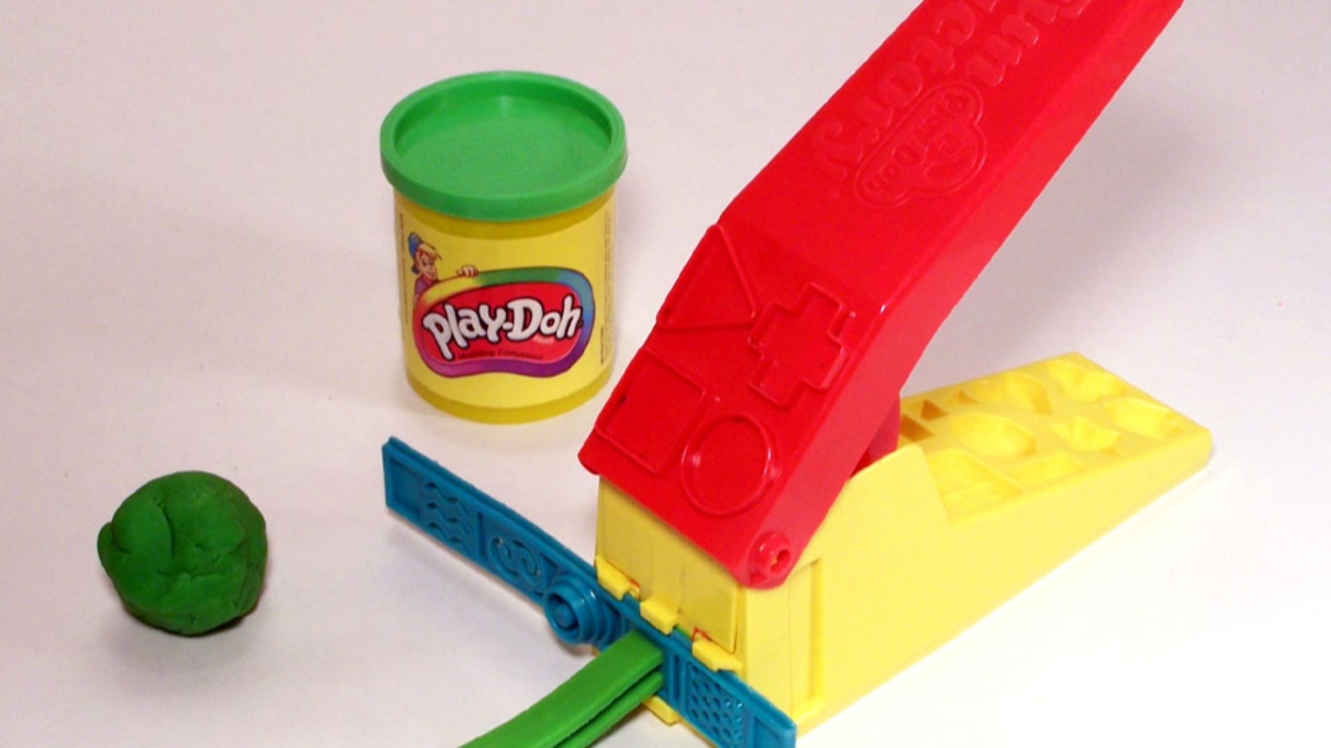 Green Play-Doh with can and accessory toy  (Play-Doh is a trademark of Hasbro).