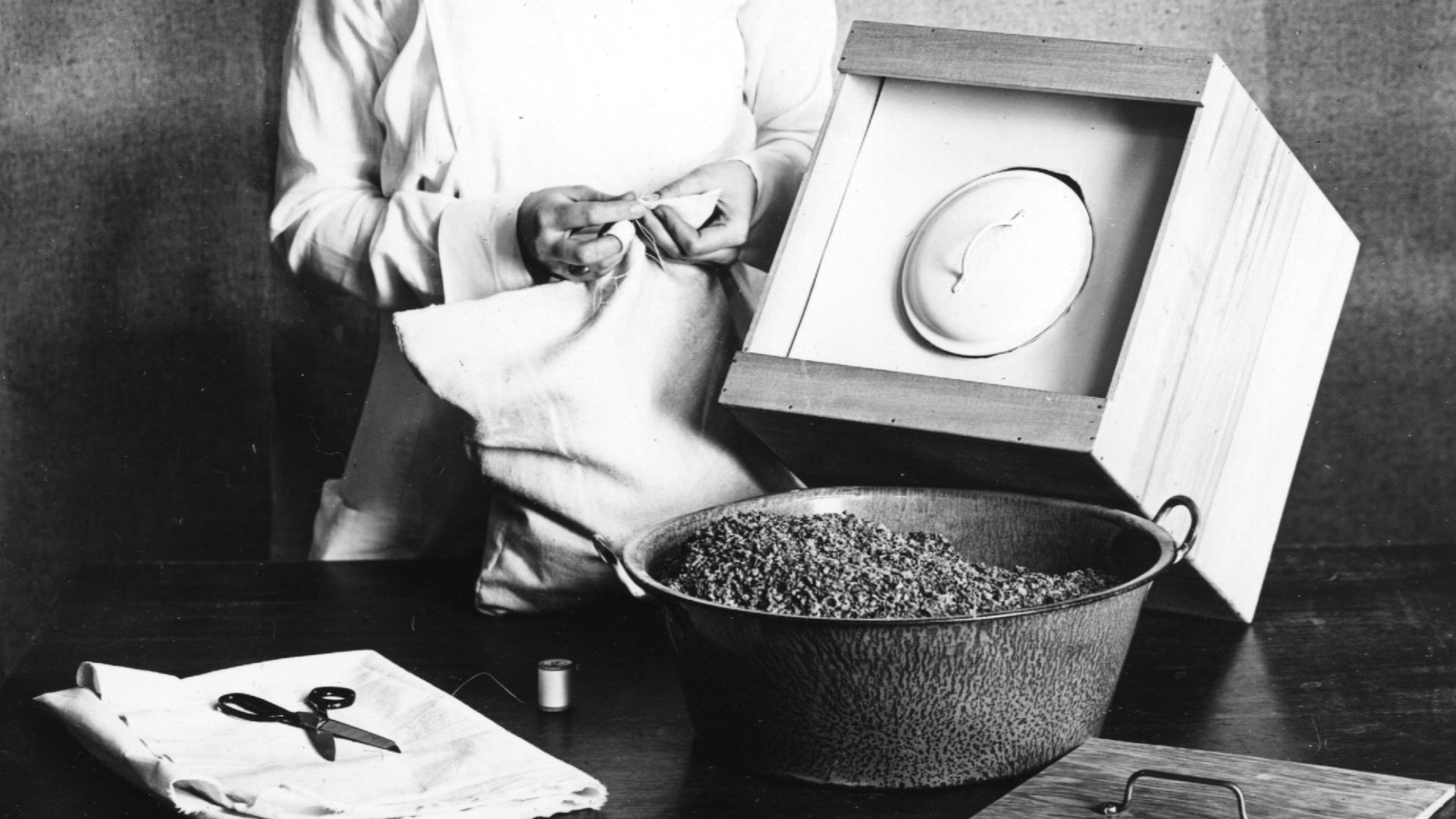 Collection: Human Ecology Historical Photographs
Title: Series of photographs showing how to make a fireless cooker at home. Taken in 1921 by Troy for Miss Blinn for Bulletin H-135, Fireless and Steam Pressure Cookers.
Collection #23-2-749, item DD-HEM-20