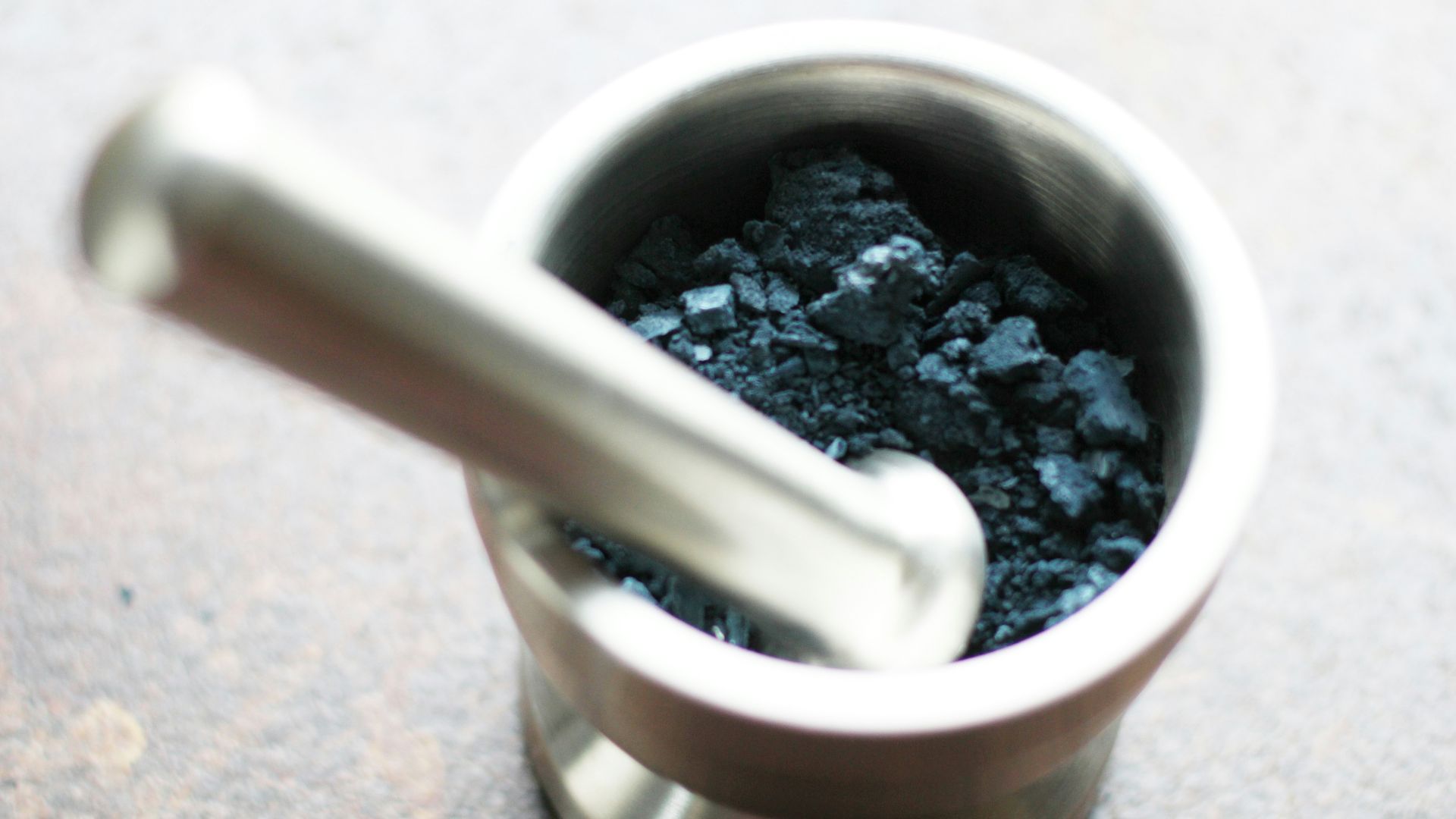 a metal cup filled with a blue substance