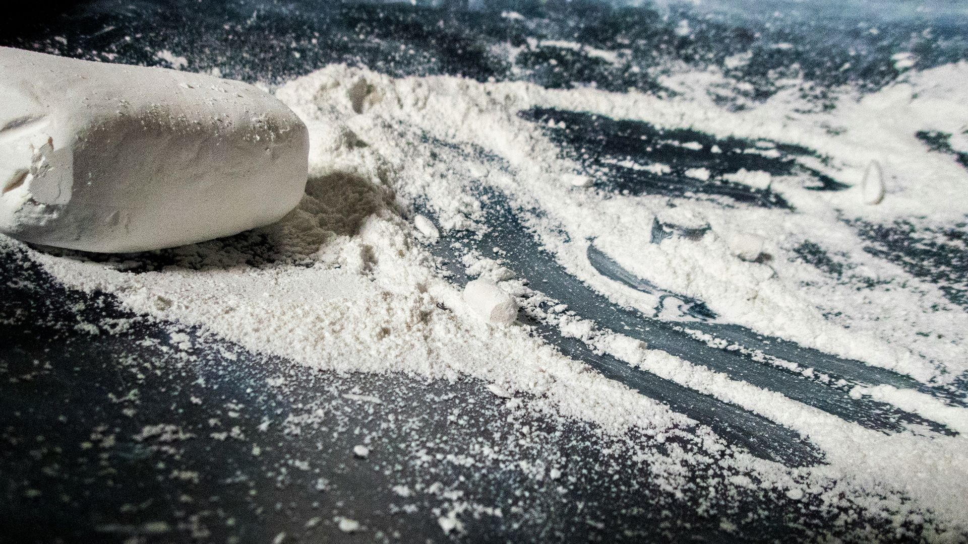 dough and flour on black surface