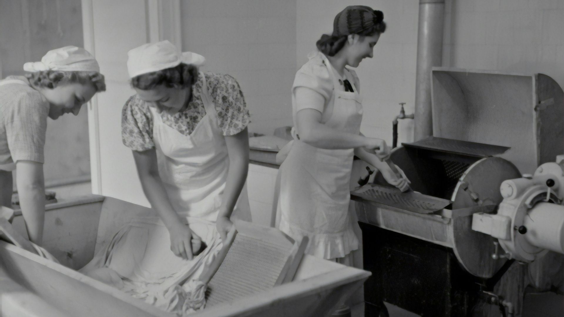 grayscale photography of three women washing clothes