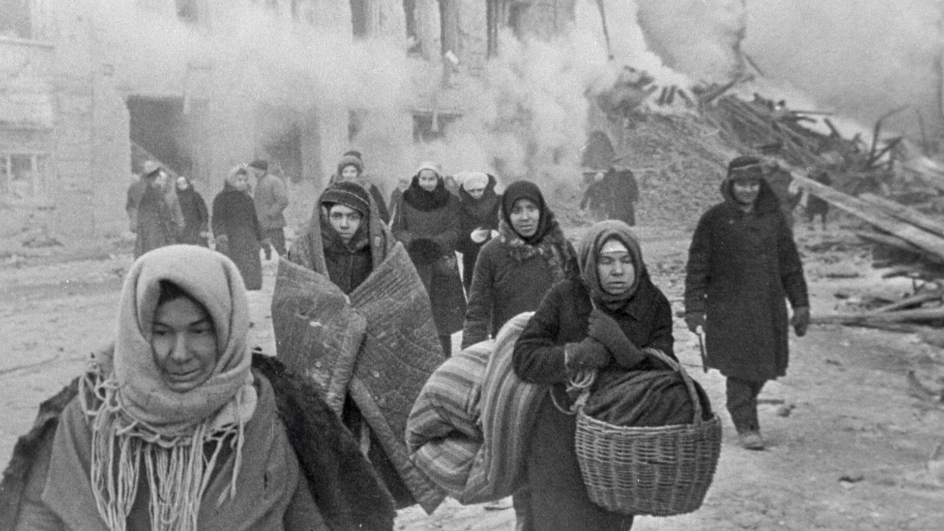 “After bombing”. Citizens of Leningrad leaving their houses destroyed by German bombing.